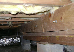 sagging crawl space with wooden shimming a Kingman crawl space
