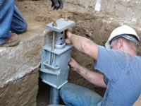 Foundation repair contractors installing the foundation bracket in Glendale.