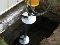 Installing a helical pier system in the earth around a foundation in Scottsdale