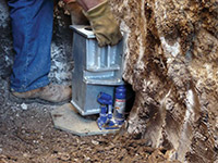 Securing a foundation footing bracket for a foundation repair system in Tempe.