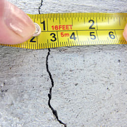 A crack in a poured concrete wall that's showing a normal crack during curing in Safford