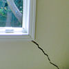 A long, diagonal crack that begins at a window corner of a Surprise home
