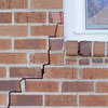 long jagged cracks starting at the corner of a window along a brick wall on a Lake Havasu City home