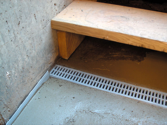 Grated Drainage Pipe System In Phoenix Mesa Glendale Scottsdale A Hatchway Entrance In Bullhead City That Has Been Protected From Flooding By Our Trenchdrain Basement